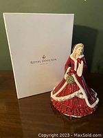 Overall view of Royal Doulton Christmas Wish 5429 figurine and original box on a wooden surface