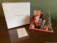 Figurine with original box and certificate laid out for scale and completeness