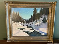 Front view of framed painting showing winter landscape