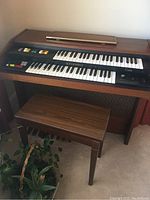 Full view of Hammond Cadette organ with matching bench showing overall design and condition.