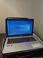 Laptop open inside case showing screen and keyboard