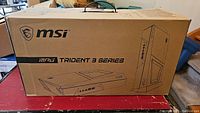 Closed cardboard MSI MPG Trident 3 Series box showing branding and illustration