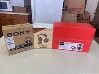Three boxes of headphones: Sony DR-7, Yorx HP-303, Sony MDR-RF985 arranged side by side on a table.