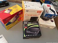 Overview of all boxed items on table: internal and external drives, DVD drive, adapter and antenna