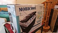 Photo of the Mobicool T35 portable cooler box showing the model and branding.