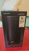 Front view of the sealed Samsung R5 Wireless Audio Radiant 360 box showing the speaker image and brand name.