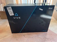 Front of sealed retail box showing Vive logo, product graphic, and overall packaging