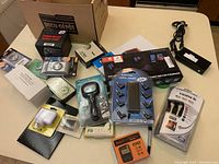 Overview of all items included showing various electronic accessories, cables, and boxed items.