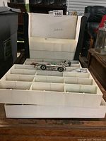 White plastic organizer tray filled with toy cars inside a carrying case