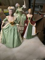 Three Franklin Porcelain figurines: Isabella of Spain, Marie Antoinette, and Sophia the Allemande, showing front and side views to highlight detail and condition.