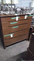 Front view showing five horizontal drawers and overall finish