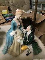 Front three-quarter view of figurine showing stance and color.