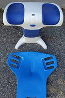 Photo showing the white Back Life device with blue padded supports designed for back posture support, beside the blue Abdominizer seat.
