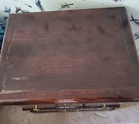 Top view of wood veneer bedside table showing scratches and surface wear
