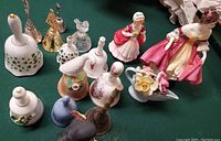 All items in the lot including two Royal Dalton figurines and assorted bells.