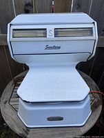 Front view of the white metal Sanitary deli scale, showing the dial and balance beam weight display.