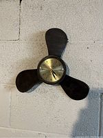 Wall mounted clock with propeller blade design visible showing the item for sale
