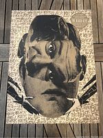 Front side of the poster showing the surrealistic black and white image with overlapping faces and background text.