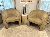Front view of both chairs side by side on area rug with side table in between