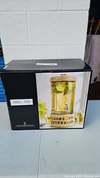 Photo of the beverage dispenser box showing the product image with a cold beverage inside the dispenser.