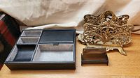 Men's jewelry box with compartments, vintage brass letter holder, and plastic business card holder displayed together