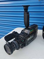 Close-up viewed from front side showing lens, microphone, and control panel of Sony Video8 Handycam camera.