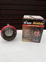 Photo of the Mr Heater Little Buddy Compact Propane Heater with its original box, showing front view of heater and product packaging.