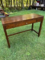 Full view of the wooden sofa table with a drawer, showing the overall structure and condition.