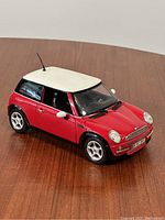 Front and side view of the red and white 2001 Mini Cooper model showing paint and body condition.