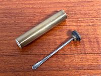 Image showing brass cylindrical oil bottle separated from screw cap with metal applicator attached inside the cap.