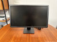 Front view of Dell 24-inch LCD monitor showing a matte screen and black bezel with Dell logo centered beneath the screen.