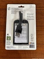 Back view of the Woods block heater timer in its original sealed blister packaging showing the cord, plug, and informational text.