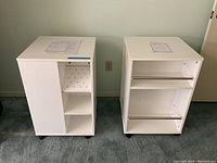 Front view of the two white storage cubes showing shelving and missing pegs