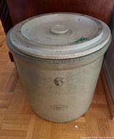 Front view of the ceramic crock with lid showing overall size and shape.