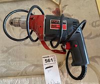 Photo showing the full Skil Xtra Tool 599 corded drill with attached chuck tool and wrapped power cord.