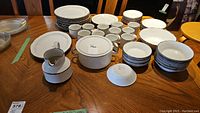 Full set of various Stonehenge Midwinter dinnerware items arranged on table including plates, bowls, teacups, cooking pot, and jug.