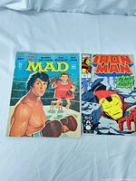 Photo showing front covers of Mad Magazine #194 October 1977 with Sylvester Stallone Rocky parody and Iron Man Vol 1 No. 267 comic from 1991