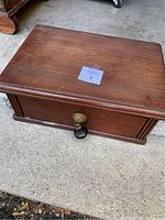 Top and front view of the antique wooden desktop box showing the overall shape and finish.