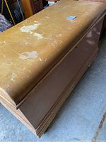 View of the rectangular cedar chest showing the top surface with peeling finish and scratches.
