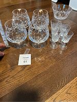 Photo showing all four snifters, six sherry glasses and the random glass arranged on a table with a measuring tape for size reference.