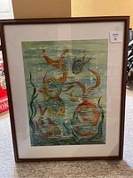 Full view of watercolour painting showing goldfish underwater, framed with white matte and brown frame.