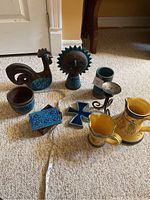 Close-up of ceramic sun face bust with turquoise glazed rays