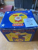 Top view of boxed Schylling Jack In The Box toy showing clown face and branding