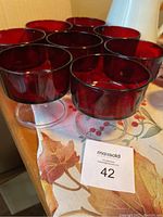 Set of 8 ruby red dessert cups made by Luminarc, showing their size and color.