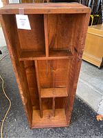 Full view of the rectangular wooden crate showing internal compartments made by vertical and horizontal wooden panels.