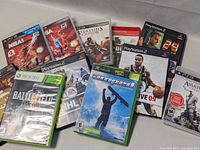 Photo of 11 video games including PlayStation 2, PlayStation 3, Xbox and Xbox 360 titles showing front covers and cases