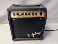 Front view of Epiphone Studio 10 guitar amplifier showing control panel with inputs, knobs, power switch, and Epiphone logo on speaker grille.