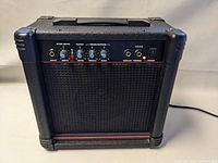 Front view showing control panel with input, drive, level, treble, bass knobs, tape/CD and phones jacks, and power switch.