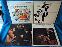 Four vinyl albums with guitar themes arranged in a grid, showing covers of Mexicana Segovia, Cante Flamenco, Julian John 2, and The World of Guitar.