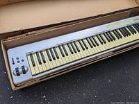 M-Audio Keystation 88es keyboard controller in original box showing full length and pitch/modulation wheels end.
